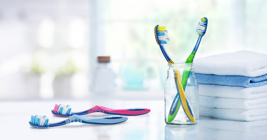 TRISA Flexible Head toothbrush placed in a glass to showcase its adaptive head and everyday usability.